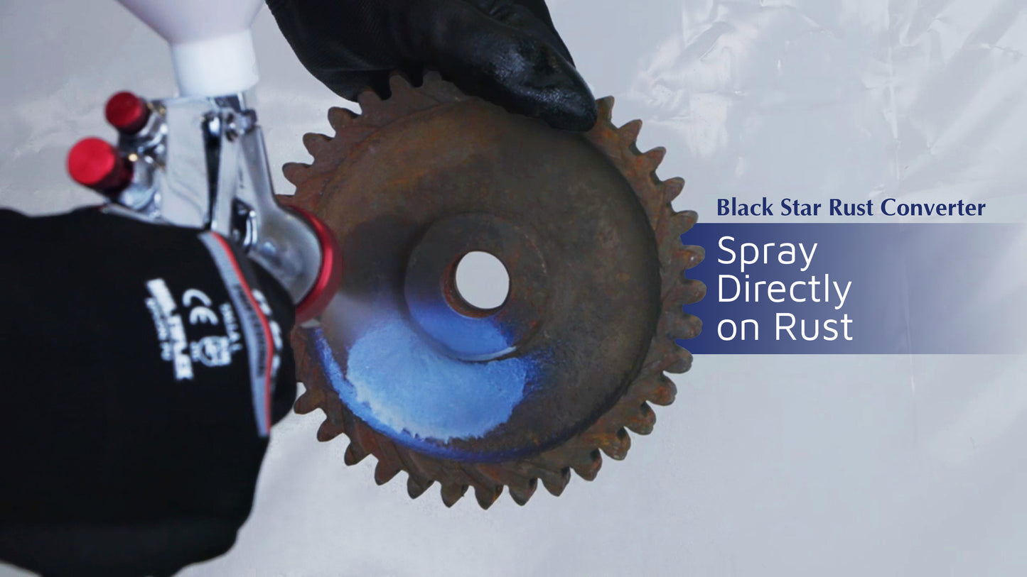 Gloved hands spraying Black Star Rust Converter onto a rusty gear, with the blue spray covering part of the rusted surface