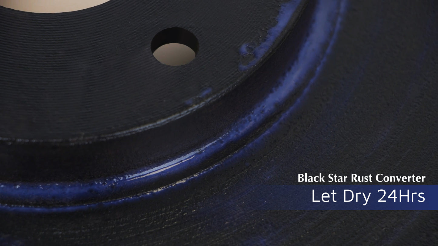 Close-up of a metal surface coated with Black Star Rust Converter, showing a glossy blue-black finish with text indicating to let it dry for 24 hours