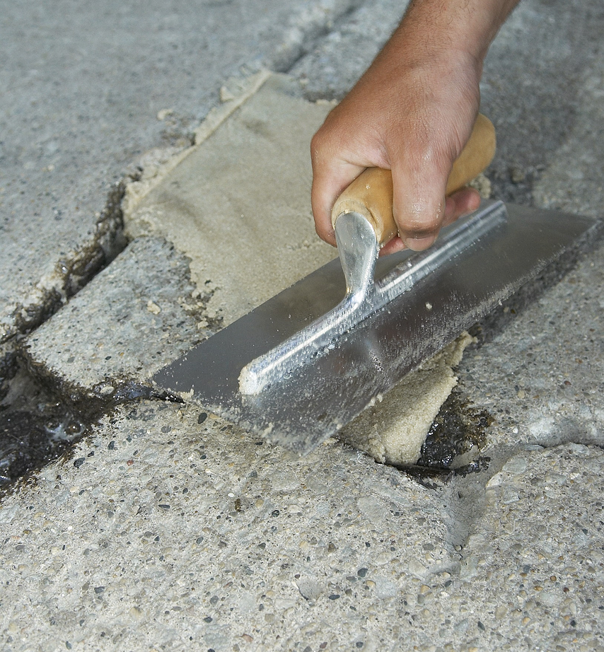 Images showing the measurement and repair of cracks in concrete.