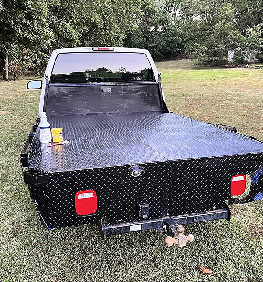 Pickup truck with a black diamond plate flatbed, featuring a bottle of Black Star Rust Converter and a cup placed on the bed