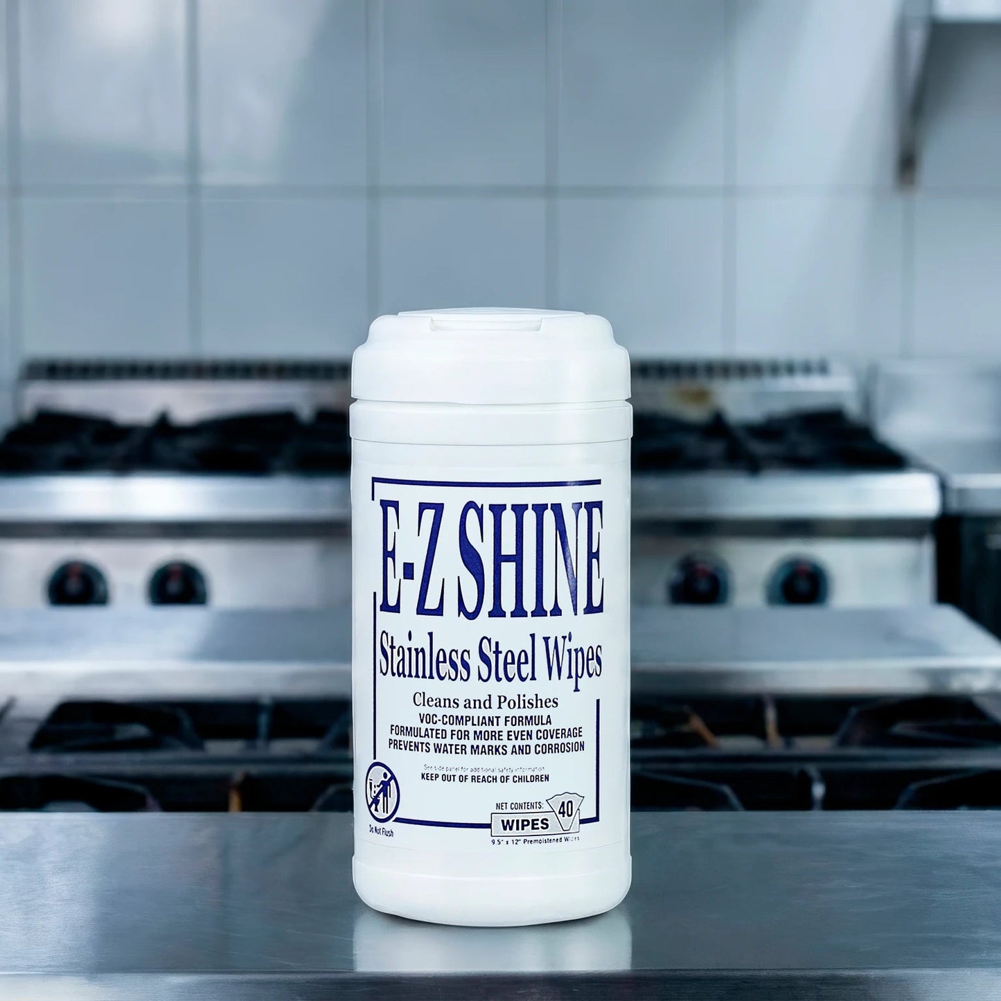 Container of EZ Shine stainless steel wipes on a kitchen counter with stovetops in the background.
