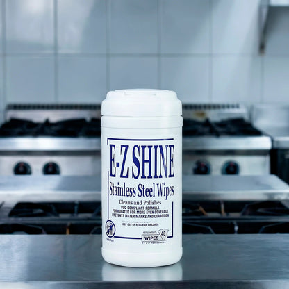Container of EZ Shine stainless steel wipes on a kitchen counter with stovetops in the background.