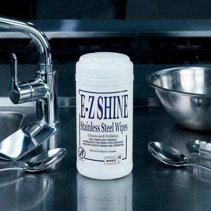 F-L-Shine stainless steel wipes on a kitchen counter with utensils and a sink.